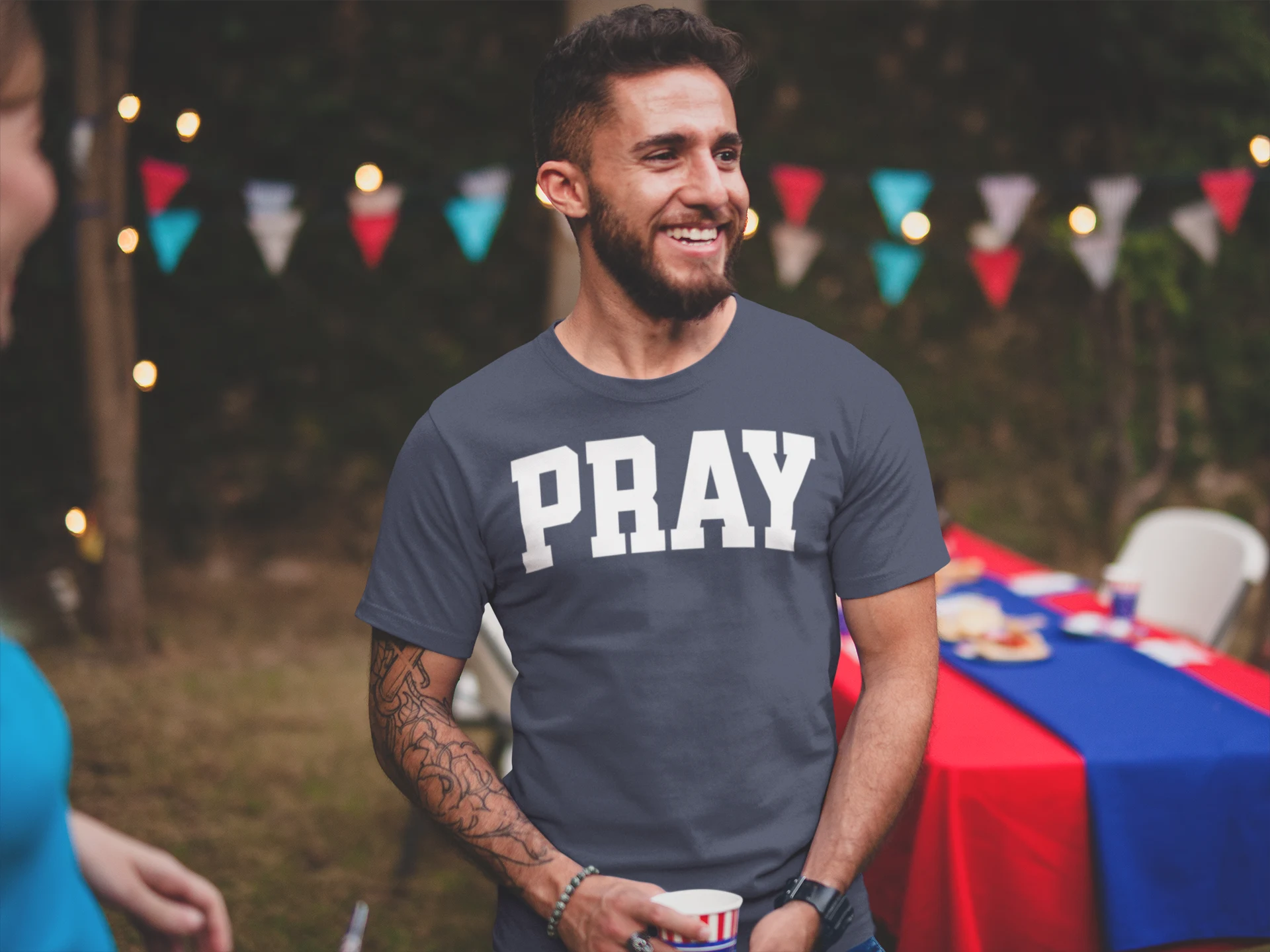 Man wearing a Pray Christian T-Shirt with bold PRAY design
