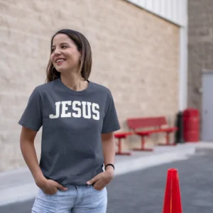 Lady with blue shirt on which has Jesus on it in large letters