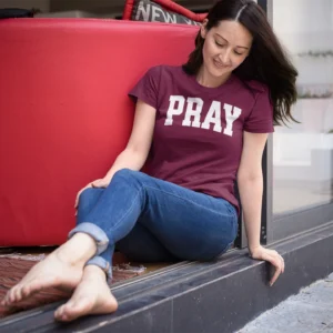Woman wearing a Pray Christian T-Shirt with bold PRAY design